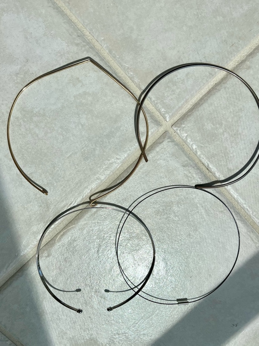 4 assorted simple choker type necklaces.
